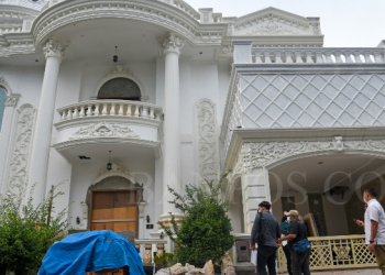 Petugas Direktorat Tindak Pidana Ekonomi Khusus (Dirtipideksus) Bareskrim Polri melakukan penyitaan satu aset tersangka kasus aplikasi trading Binomo Indra Kesuma atau Indra Kenz di Perumahan Cemara Asri, Percut Sei Tuan, Deli Serdang, Sumatera Utara, Kamis (10/3/2022). Bareskrim Polri menyita tiga aset milik Indra Kenz berupa gedung yang dijadikan kantor trading di Medan dan dua rumah pribadi di Deli Serdang. (ANTARA FOTO/Fransisco Carolio/WS/YU).