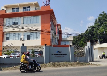 Pengendara sepeda motor saat melintasi Kantor PT Pelabuhan Cilegon Mandiri (PCM). (LUKMAN HAPIDIN/BANTEN POS)