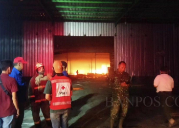 Petugas Pemadam berkoordinasi saat memadamkan api kebakaran di Pabrik Triplek